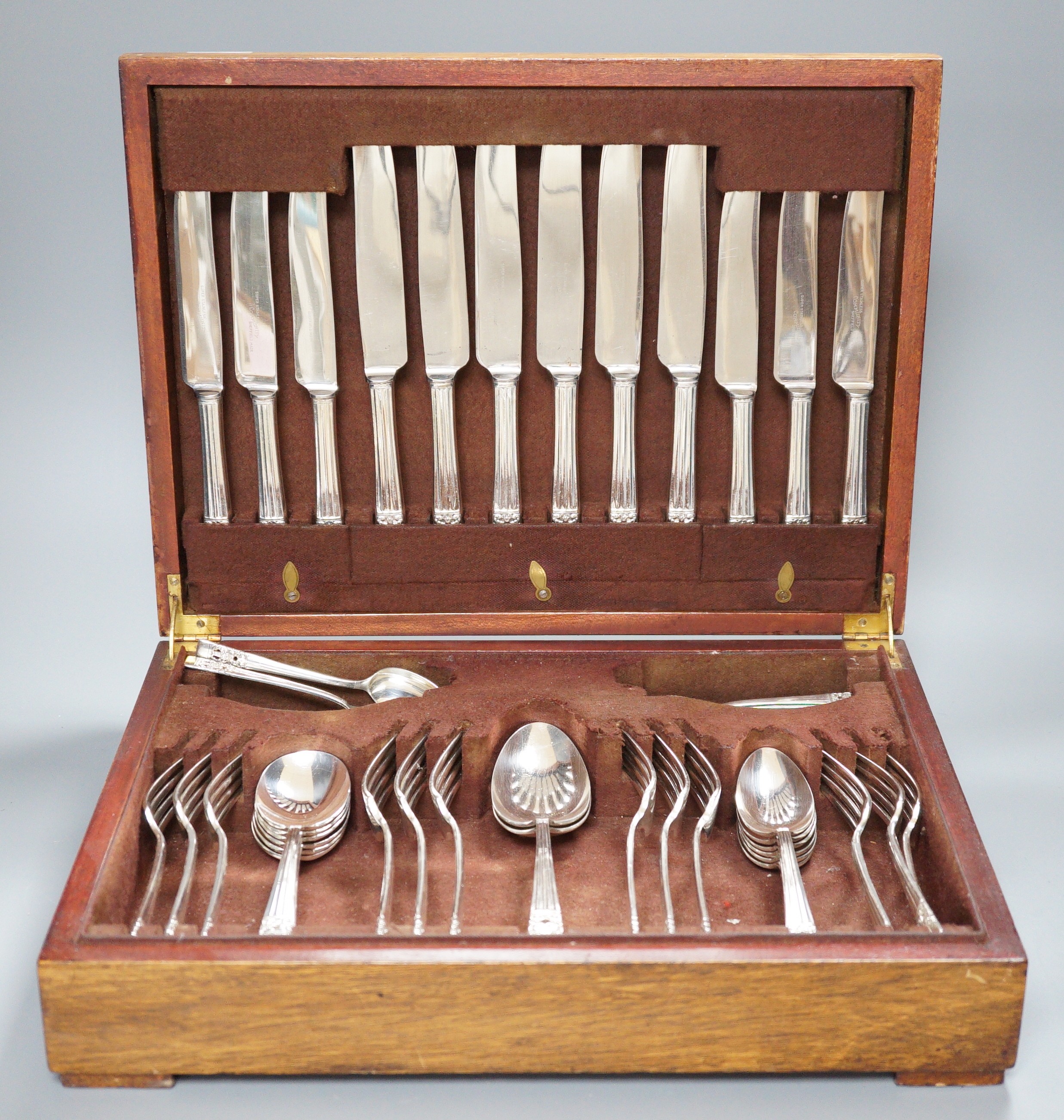 A canteen of silver plated cutlery, a four piece plated tea set and a plated egg coddler.